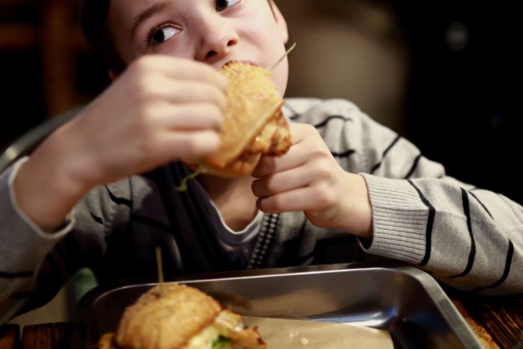 a child eating a chicken burger