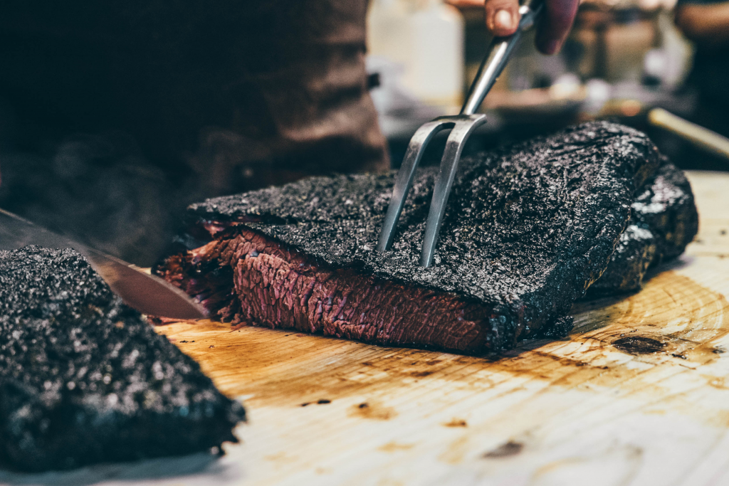 someone carving some brisket